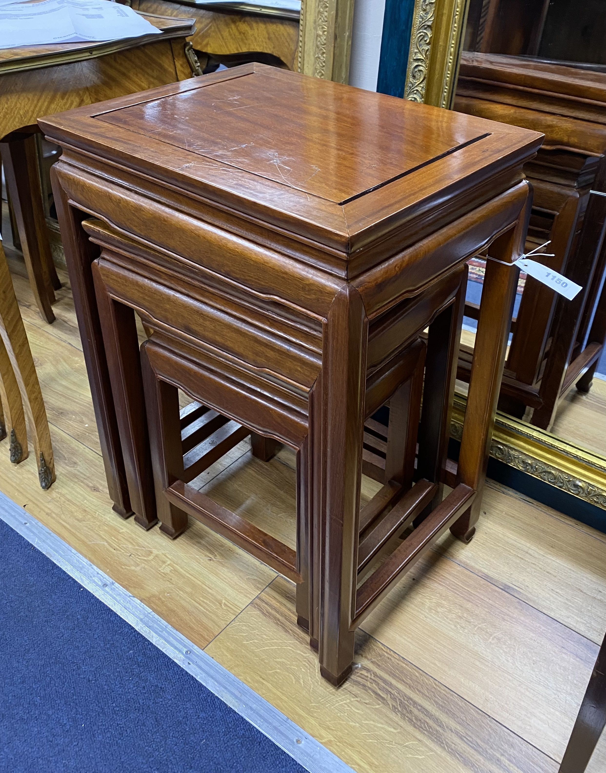 A nest of three rectangular Chinese occasional tables, width 40cm, depth 31cm, height 56cm
